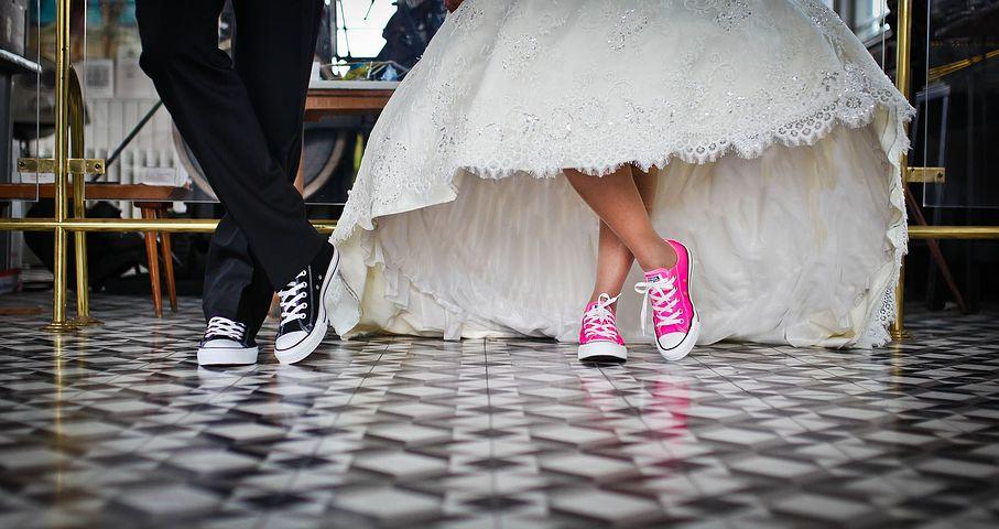 Bride and Groom's formally dressed with Converse shoes half body picture