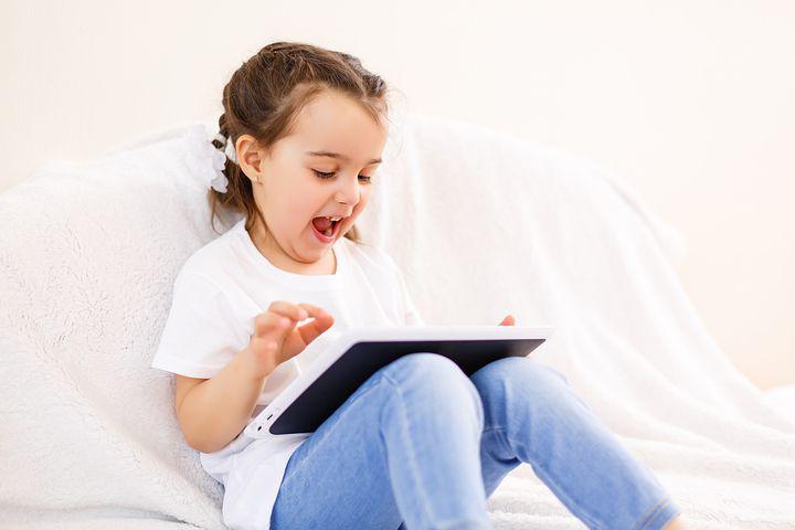 small girl playing in tablet