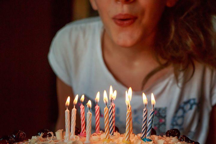 girl blowing candles