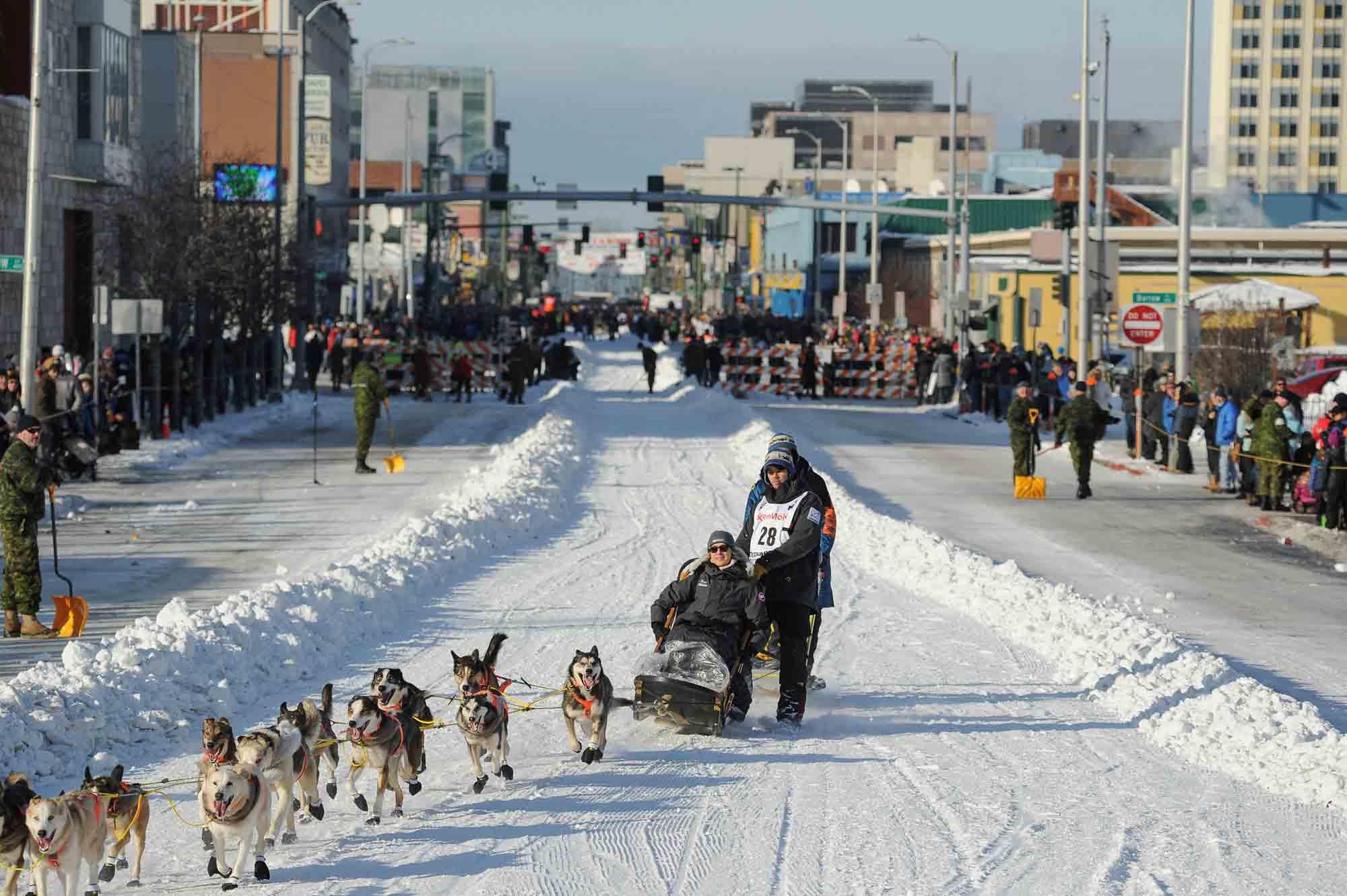 Defending Champion Joar Lefseth Ulsom runs his team down Fourth Ave during the ceremonial start of the Iditarod Trail Sled Dog Race in Anchorage, Alaska. 