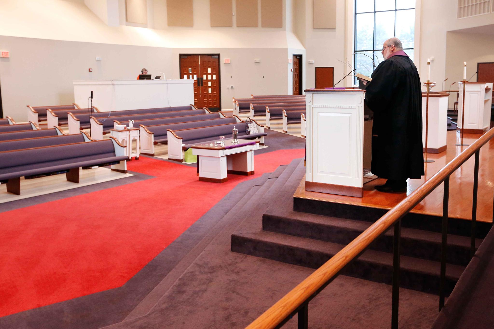 pastor in empty church, services go online during virus outbreak