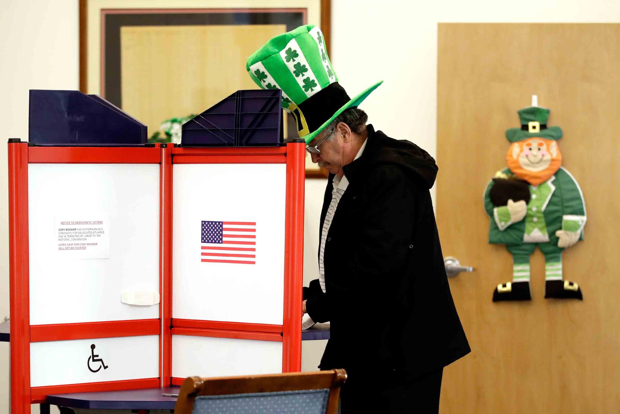 A voter fills out his ballot, taking advantage of early voting, Sunday, March 15, 2020, in Steubenville, Ohio