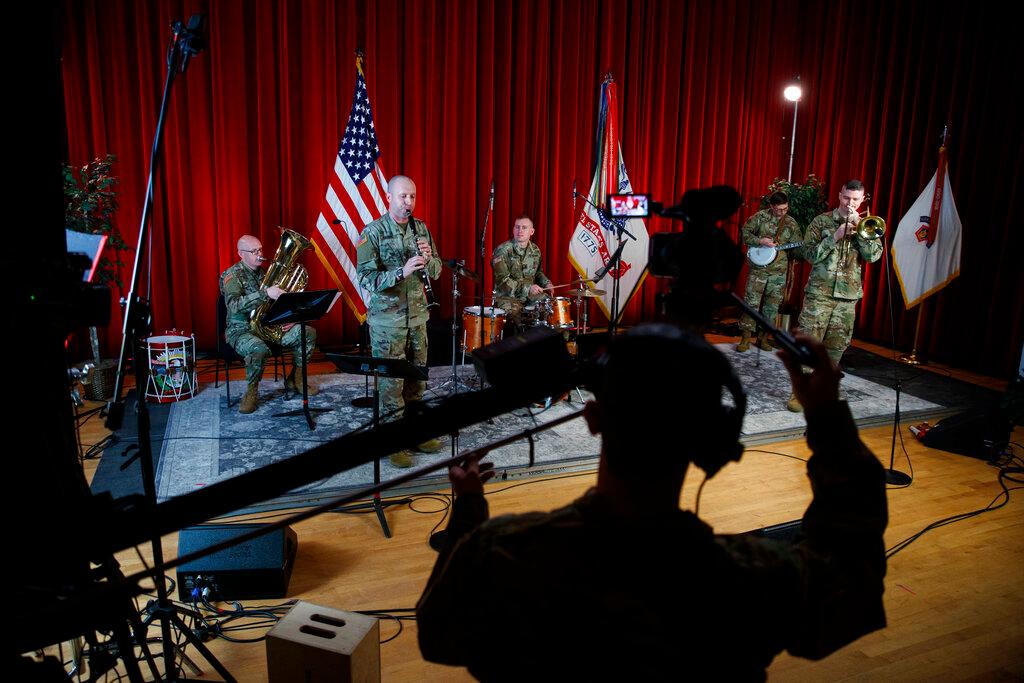 U.S. Army Field Band members from left, Chief Warrant Officer 2 Kevin Pick, on the tuba, Master Sgt. Bradford Danho, on the clarinet, Staff Sgt. Andrew Emerich, on the drums, Sgt. 1st Class Jonathan Epley, on the banjo and Staff Sgt. Kyle Johnson, on the trombone, are spaced to allow for social distancing as they play during the rehearsal of their daily "We Stand Ready" virtual concert series at Fort George G. Meade in Fort Meade, Md.