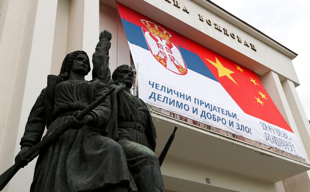 Billboard showing Serbian and Chinese flags reading: "Iron friends, together in good and evil!" 