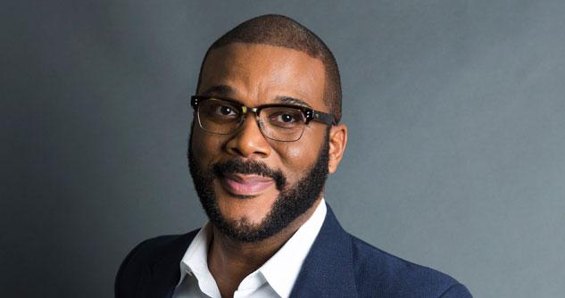 Tyler Perry in a blue sport coat and a white shirt with a gray background