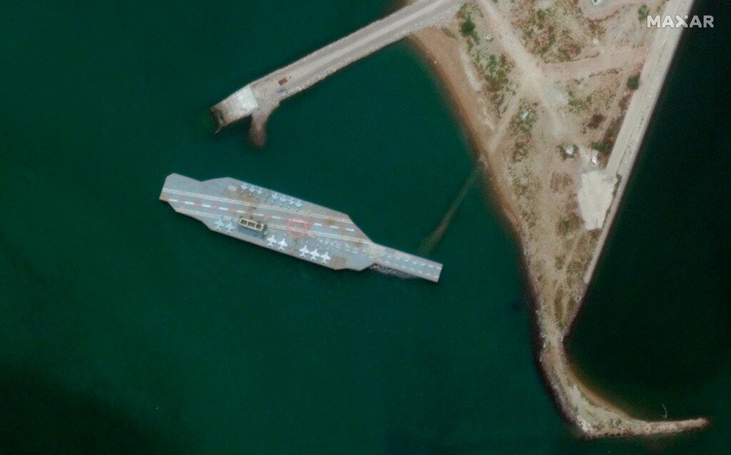 Satellite photo provided by Maxar Technologies, a fake aircraft carrier is seen off the coast of Bandar Abbas, Iran. 