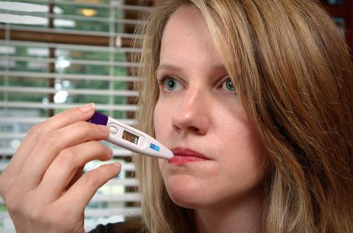 Woman taking temperature