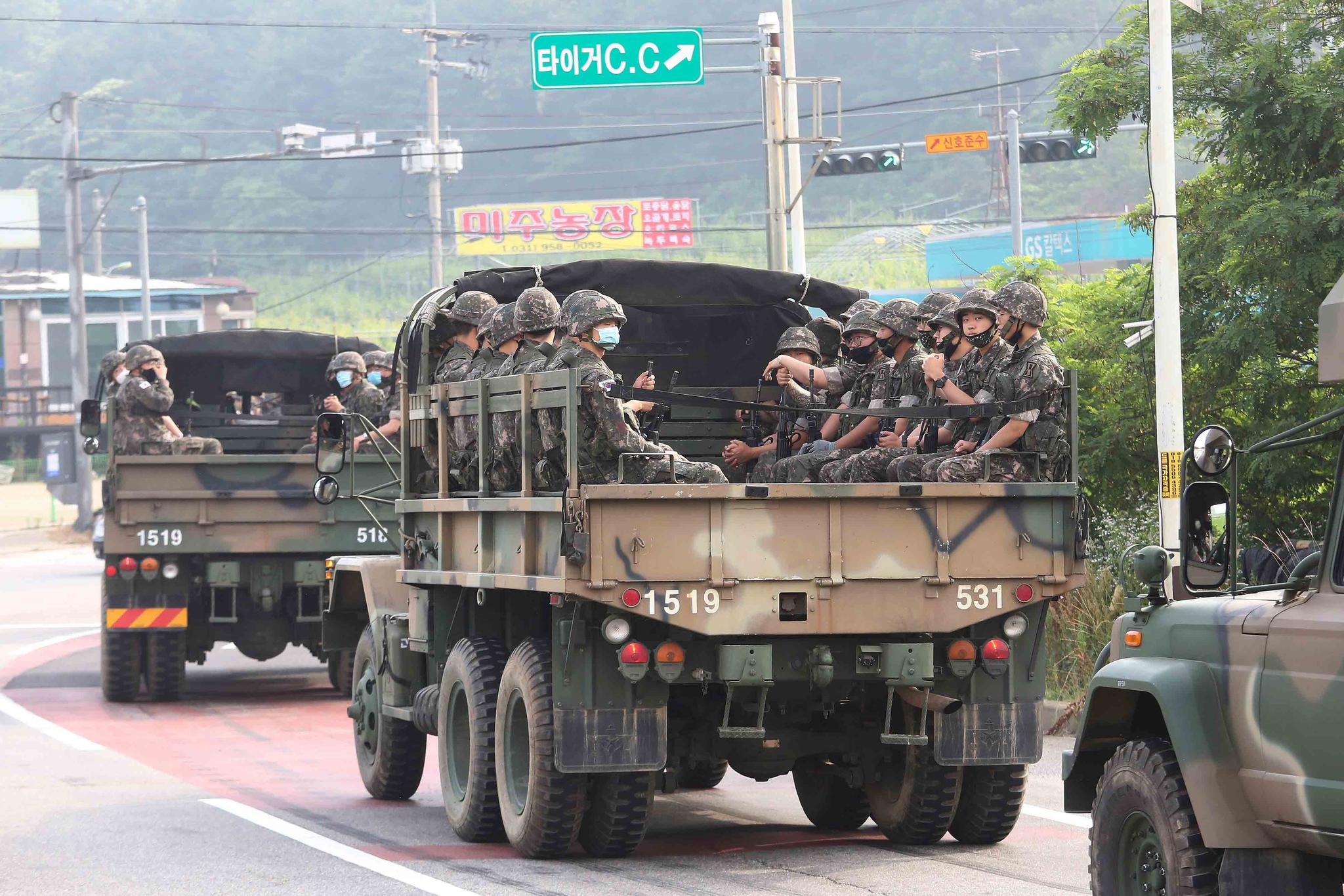 South Korean army soldiers ride on the back of trucks in Paju, near the border with North Korea, South Korea