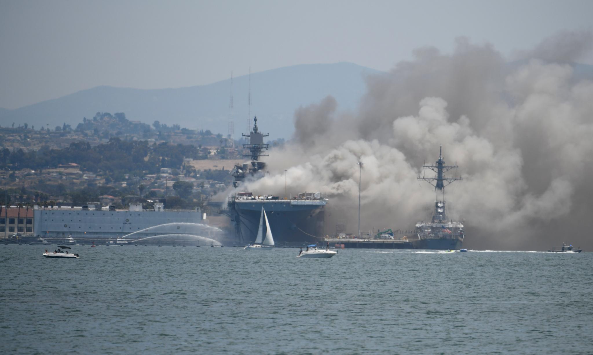 Smoke rises from the USS Bonhomme Richard at Naval Base San Diego