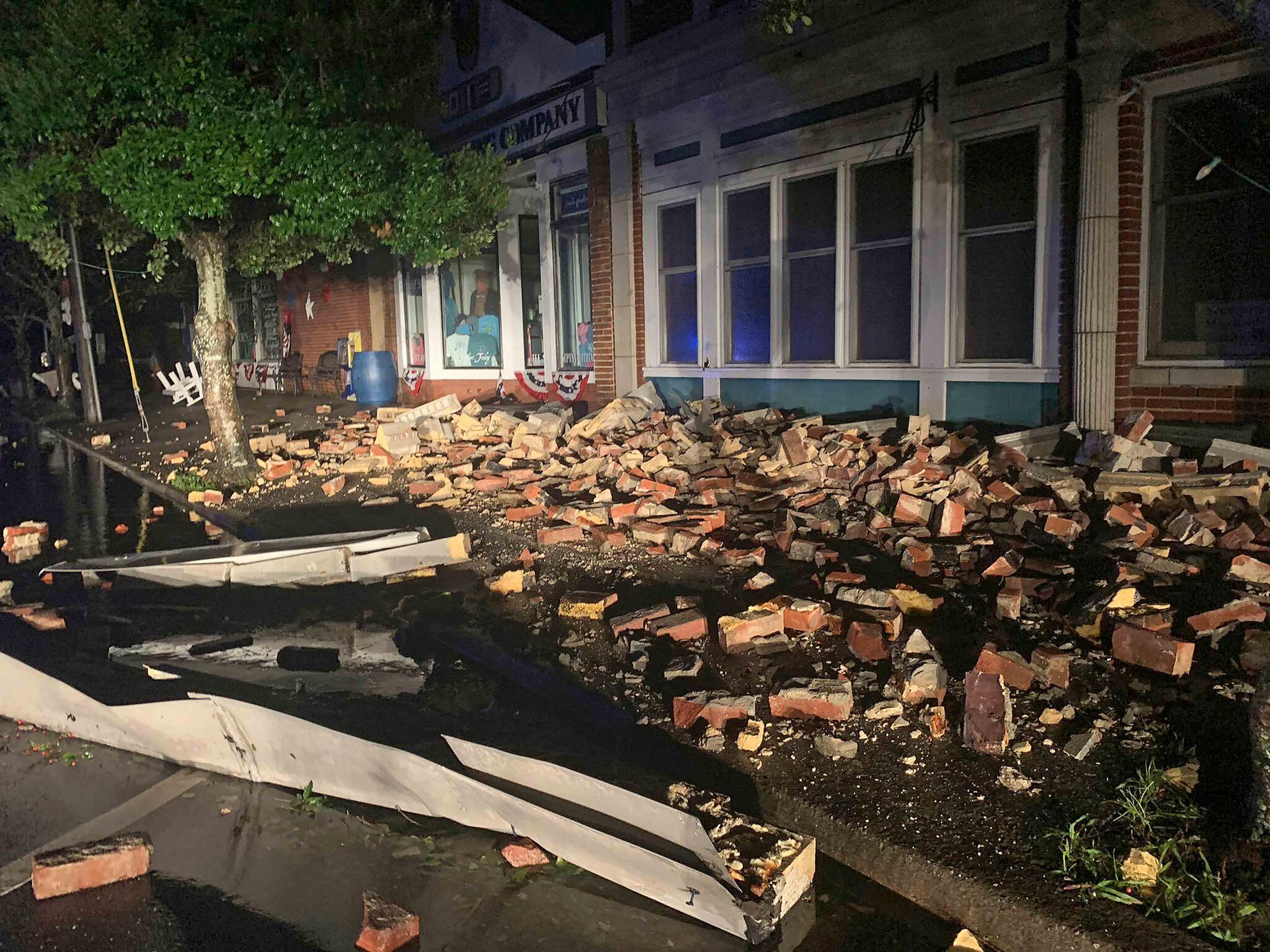 Debris covers the sidewalk in Southport, N.C. as hurricane Isaias moved through North Carolina early Tuesday, Aug. 4, 2020.