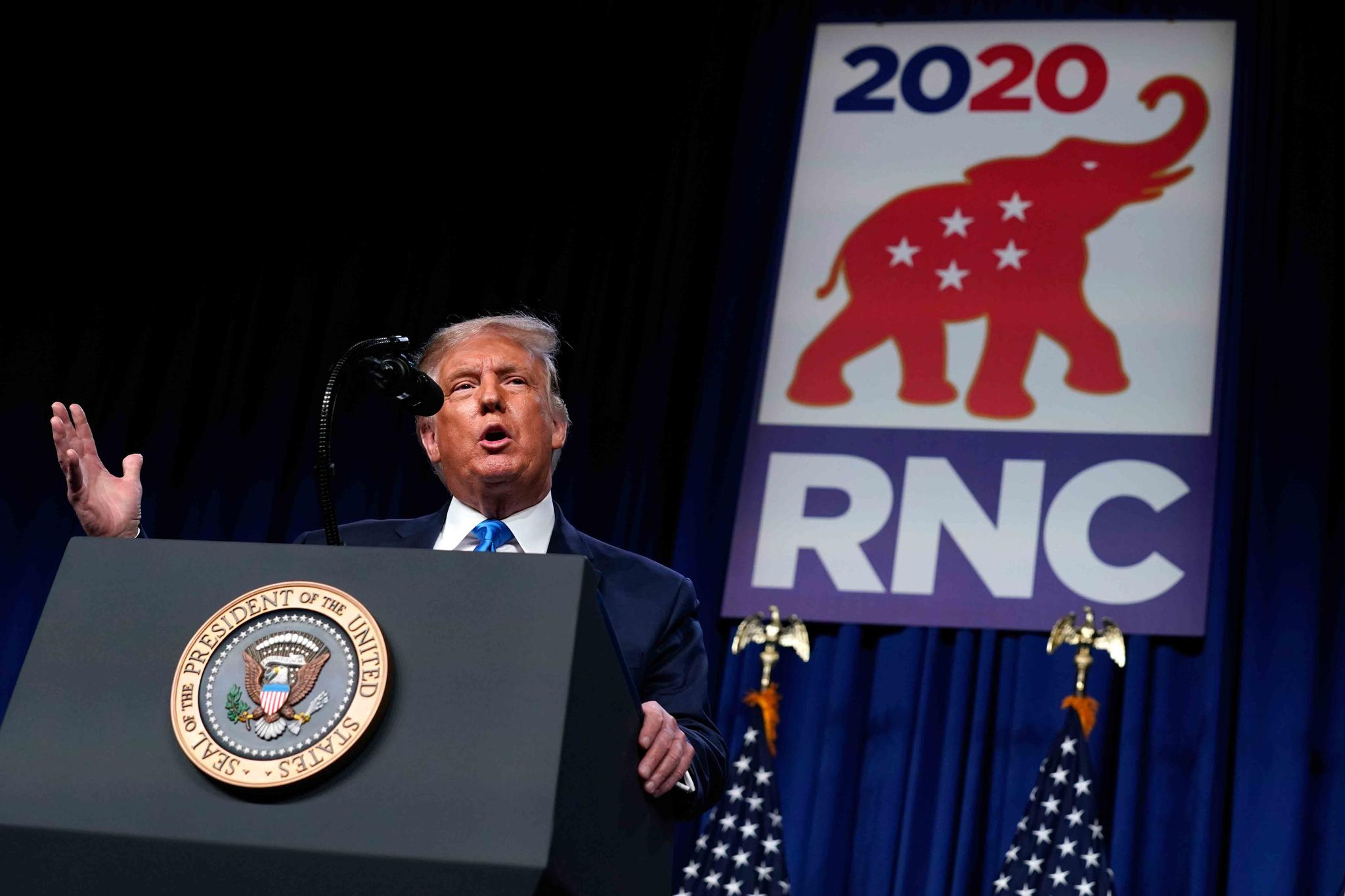 President Donald Trump speaks on stage during the first day of the Republican National Committee convention