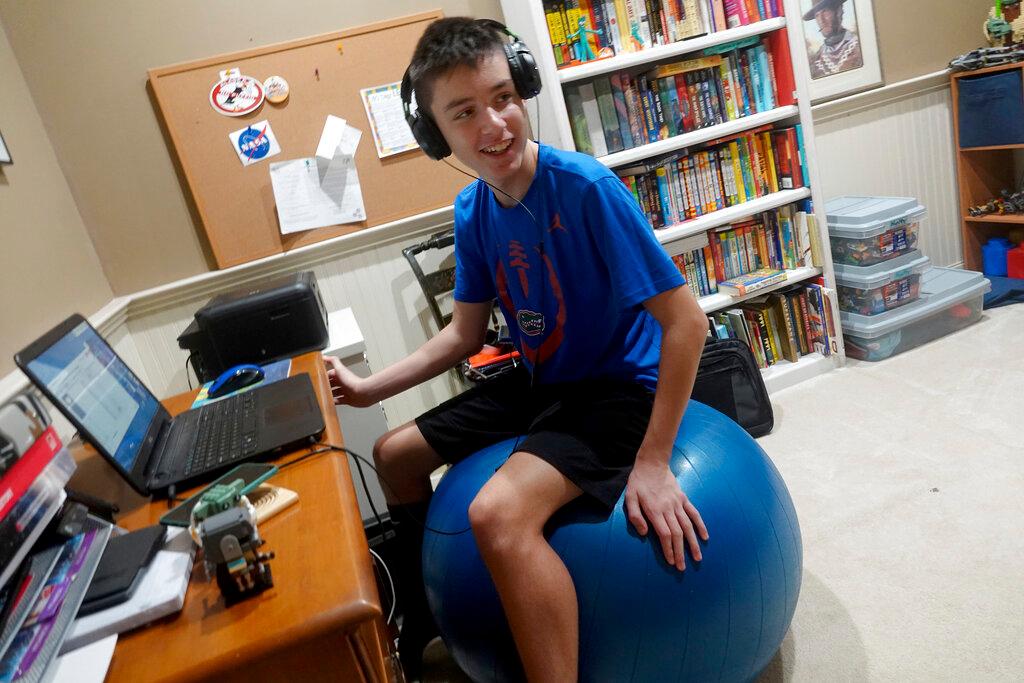 Andrew Burstein, 13, logs onto 8th grade class with Don Estridge High Tech Middle School from his home in Delray Beach, Fla.