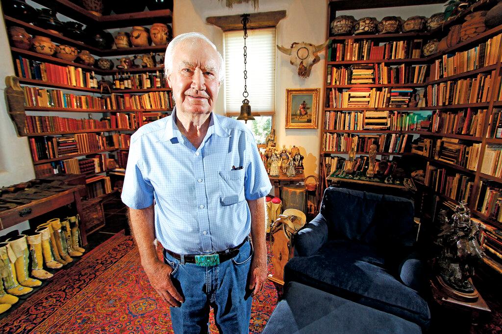 Forrest Fenn poses at his Santa Fe, N.M., home. The antiquities dealer and author who gained fame after hiding a treasure in the Rocky Mountains has died at the age of 90. 