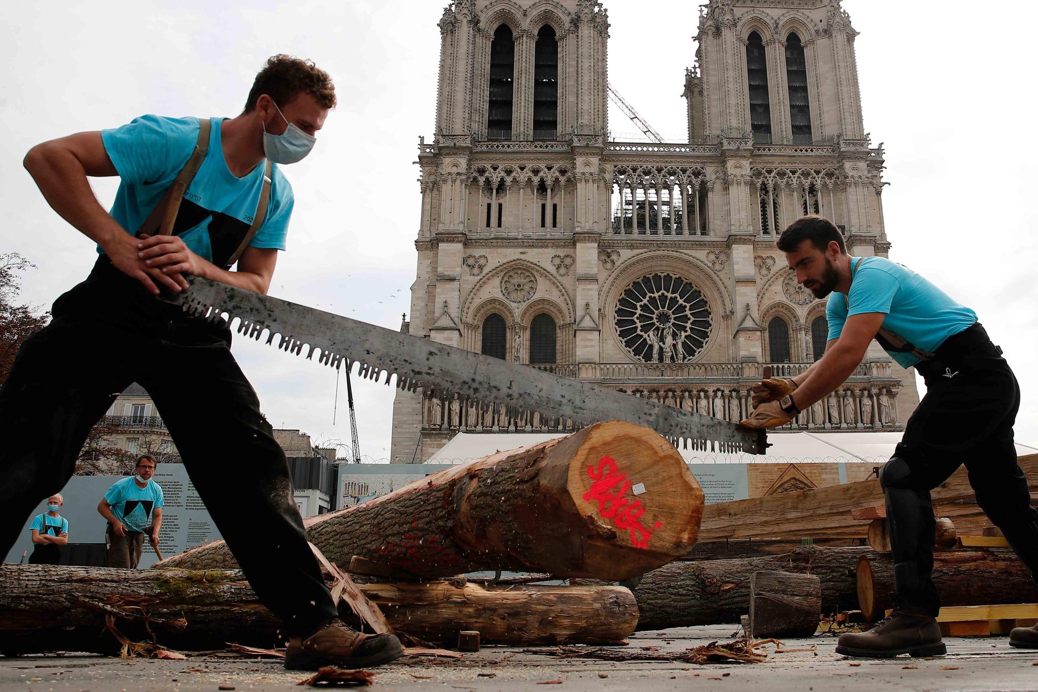 Carpenters put the skills of their Medieval colleagues on show on the plaza in front of Notre Dame Cathedral in Paris, France, Saturday, Sept. 19, 2020