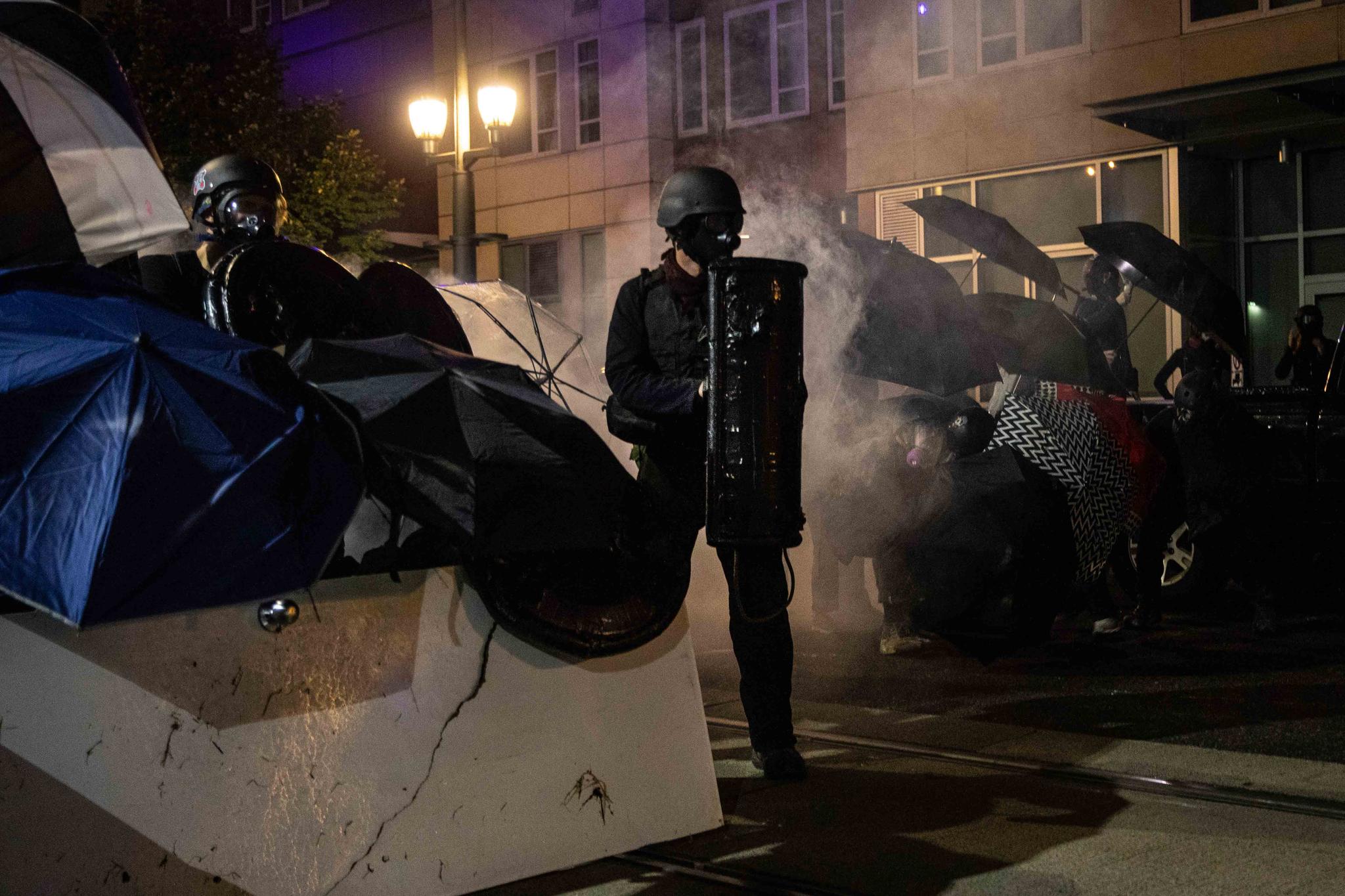 Protesters stand off with police during protests Friday, Sept. 18, 2020, in Portland, Ore.