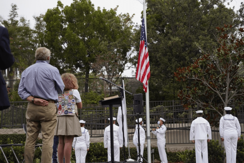 Taylor Harris stands with respect as American flag raised on new flagpole she made possible