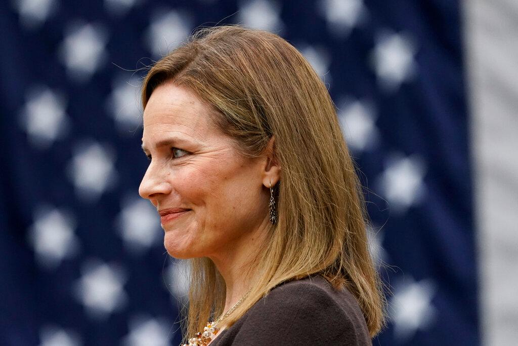 Judge Amy Coney Barrett listens as President Donald Trump announces Barrett as his nominee to the Supreme Court, in the Rose Garden