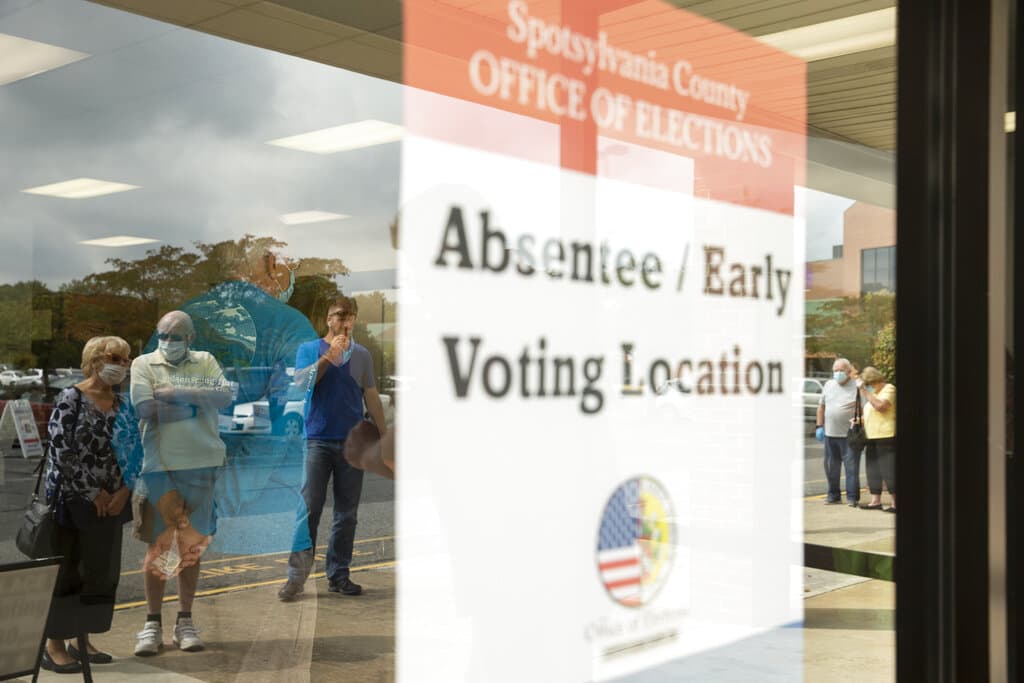 Voters wait in line to cast ballots in the general election