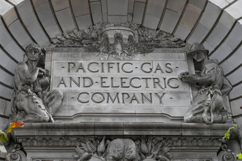 In this April 16, 2020, file photo, a Pacific Gas & Electric sign is displayed on the exterior of a PG&E building in San Francisco. Pacific Gas & Electric will cut power to over 1 million people on Sunday to prevent the chance of sparking wildfires as extreme fire weather returns to the region, the utility announced Friday, Oct. 23, 2020.