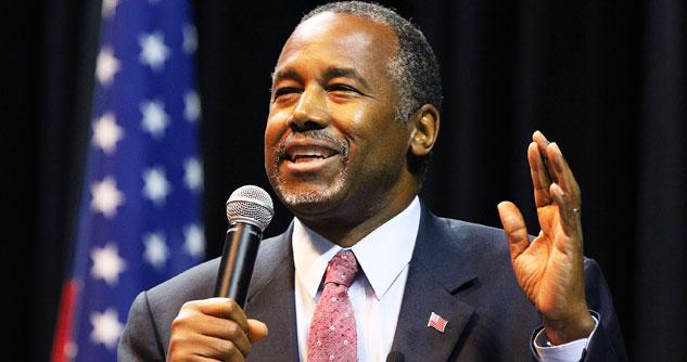 Dr. Ben Carson smiling, speaking into microphone