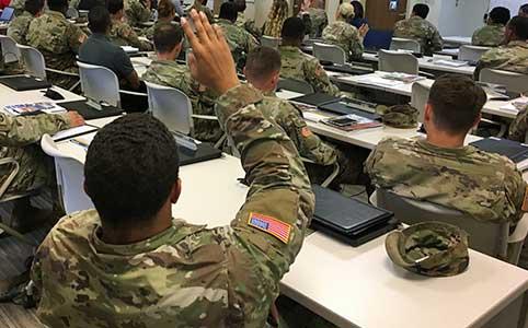 soldier raises arm to volunteer