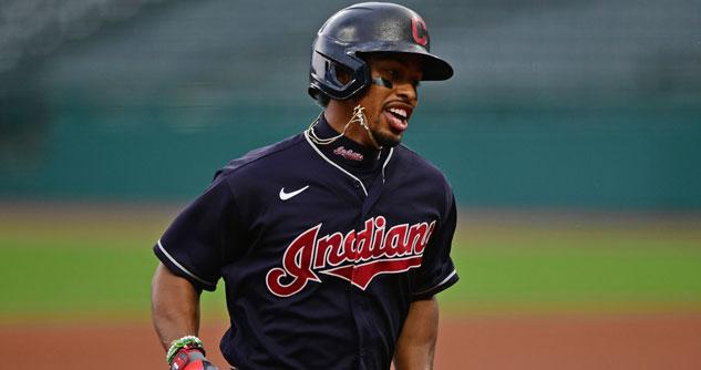 Baseball player in Cleveland Indians dark blue jersey with red letters running