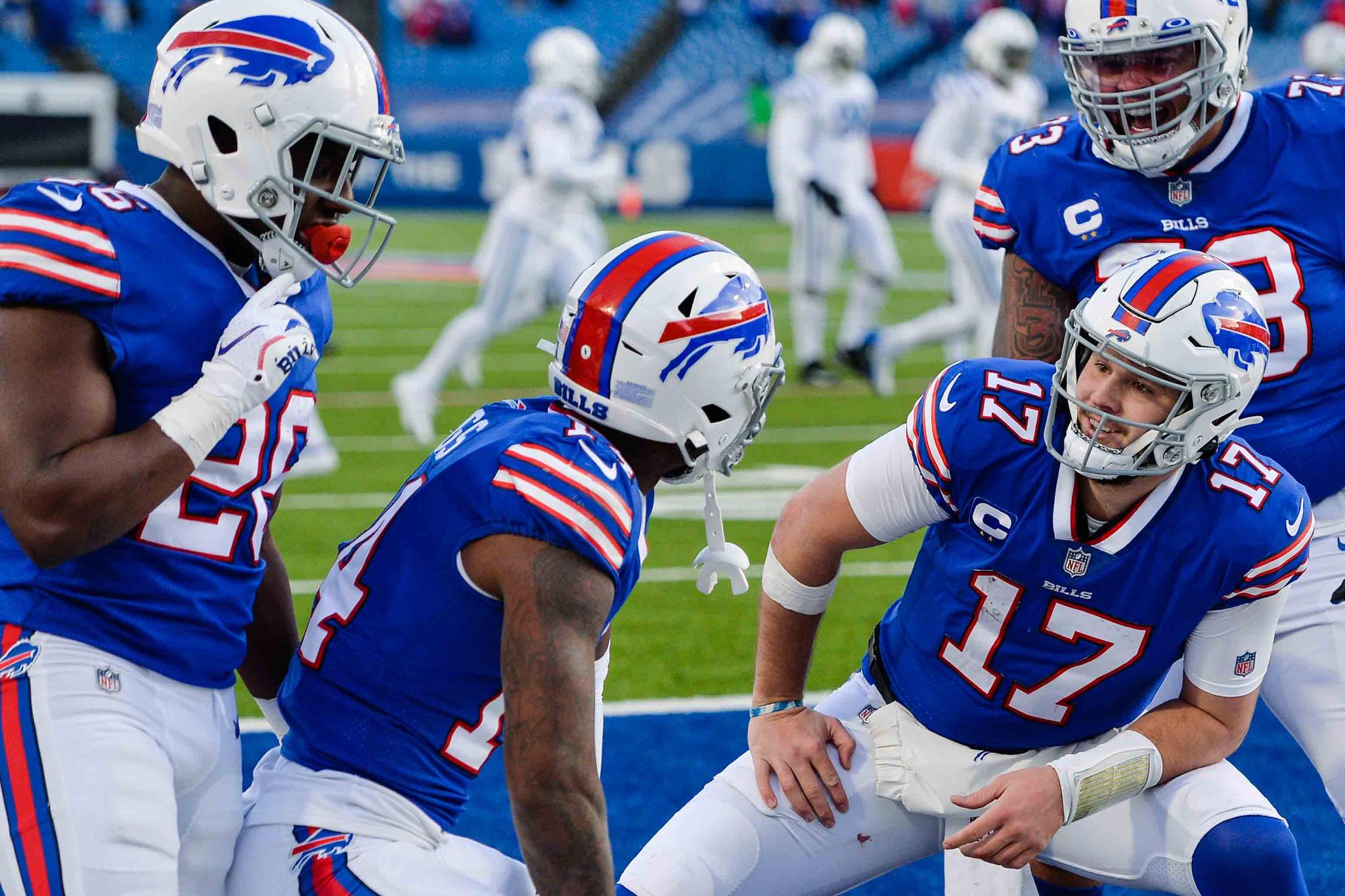 Buffalo Bills' Josh Allen (17) celebrates with teammate Stefon Diggs (14), Dion Dawkins (73), and Zack Moss (20) after connecting with Diggs for a touchdown during the second half of an NFL wild-card playoff football game against the Indianapolis Colts Saturday, Jan. 9, 2021, in Orchard Park, N.Y.