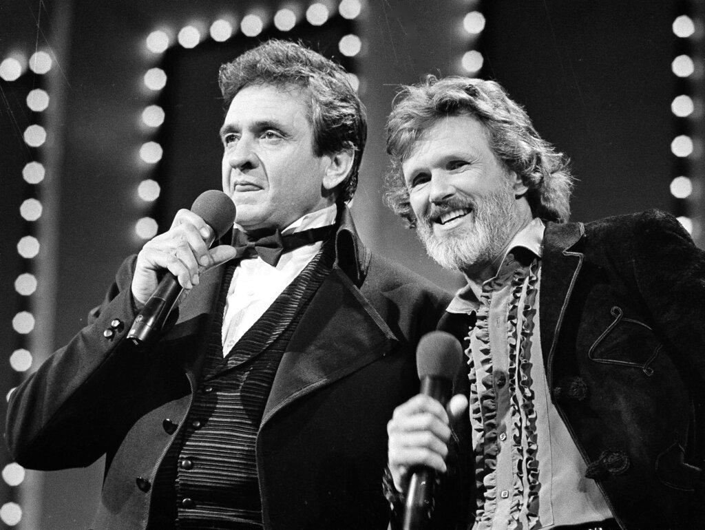 Country stars Johnny Cash, left and Kris Kristofferson sing during the Country Music Awards in Nashville, Tenn., Oct. 1983.