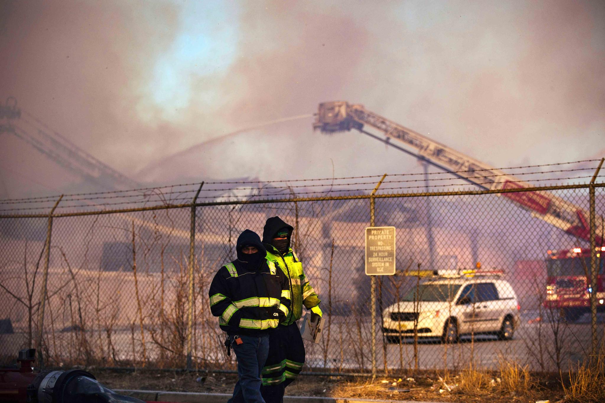 Firefighters battle a blaze in an industrial area on Saturday, Jan. 30, 2021, in Passaic, NJ.