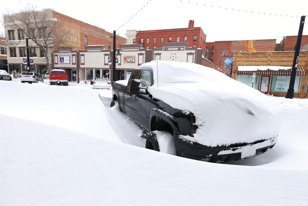 snow covered road and car