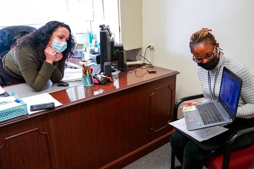 High School Councilor Nadia Pearce, right, and Coordinator of School Counseling Carli Rocha-Reaes speak to a group of Juniors and Seniors via video conference, Thursday, Feb. 25, 2021, in Bridgeport. Conn. School counselors in many urban, high needs districts have been consumed with efforts to help students engage with their schoolwork since the pandemic hit.