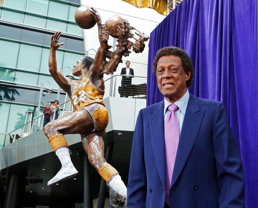 (2018) Elgin Baylor stands next to a statue, just unveiled, honoring the Minneapolis and Los Angeles Lakers great, outside Staples Center in Los Angeles