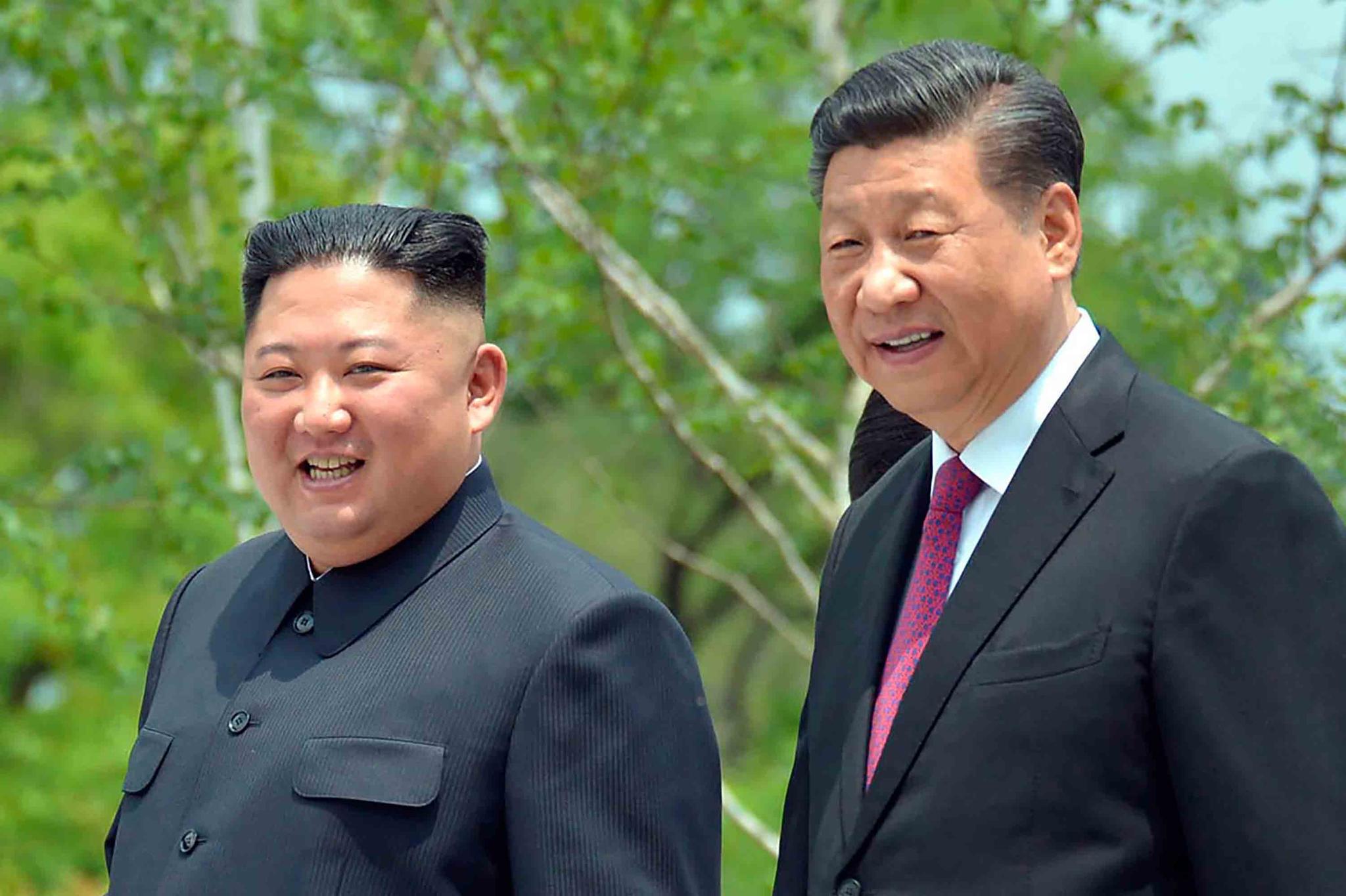 file photo provided by the North Korean government, North Korean leader Kim Jong Un, left, and Chinese President Xi Jinping stroll in the premises of Kumsusan guest house in Pyongyang, North Korea.