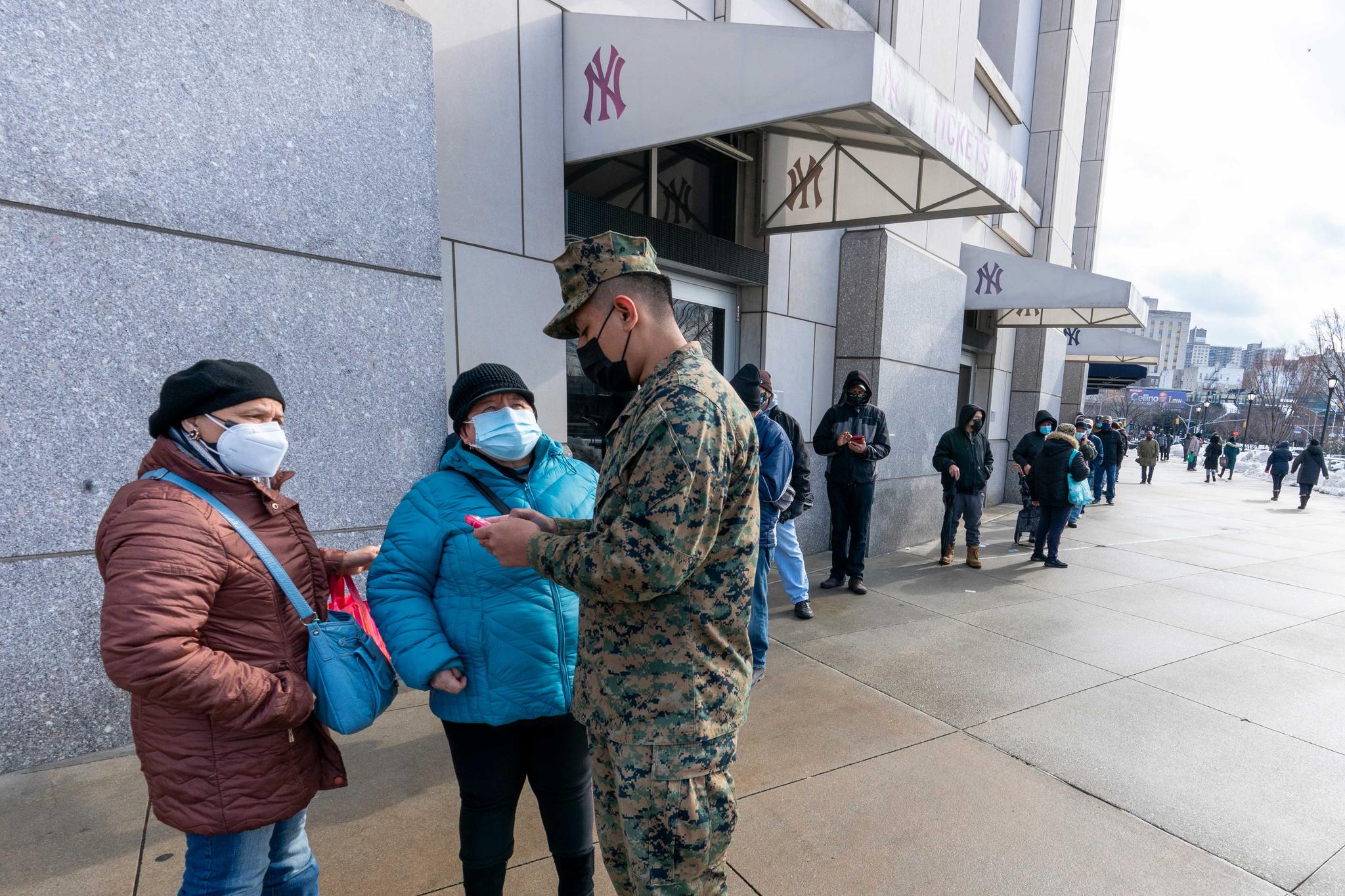 people standing in line for COVID-19 vaccine at Yankee Stadium