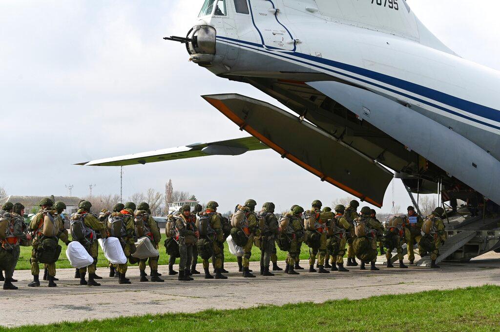 Russian paratroopers load into a plane for airborne drills during maneuvers in Taganrog, Russia