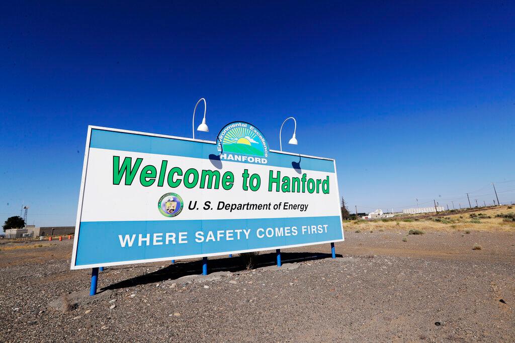 In this Aug. 13, 2019, file photo, a sign at the Hanford Nuclear Reservation is posted near Richland, Wash. Officials say an underground nuclear waste storage tank that dates to World War II appears to be leaking contaminated liquid into the ground. The U.S. Department of Energy said Thursday, April 29, 2021, that Tank B-109 holds 123,000 gallons of radioactive waste left from the production of plutonium for nuclear weapons on the Hanford Nuclear Reservation.