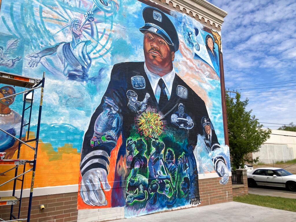 A large mural honoring firefighter Capt. Franklin Williams and other Detroit public employees who died from COVID-19 is displayed on the side of a building, Monday, May 31, 2021, in Detroit. The mural, which faces a Detroit fire station, was created by artist Charles “Chazz” Miller with assistance from students at University of Detroit Mercy, the Detroit Free Press reported. It was unveiled Sunday, May 30.