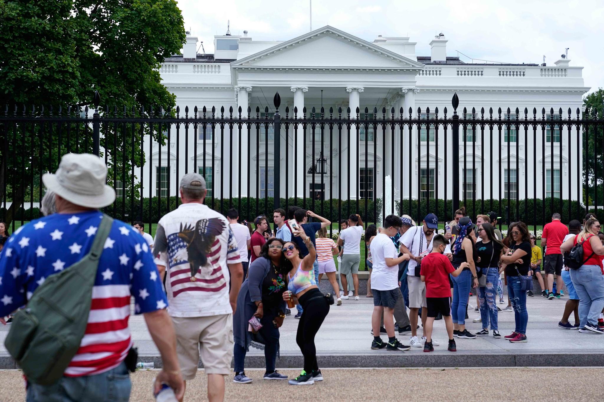 People gather on a section of Pennsylvania Avenue that was reopened to the public in front of the White House, Sunday, July 4, 2021, in Washington.