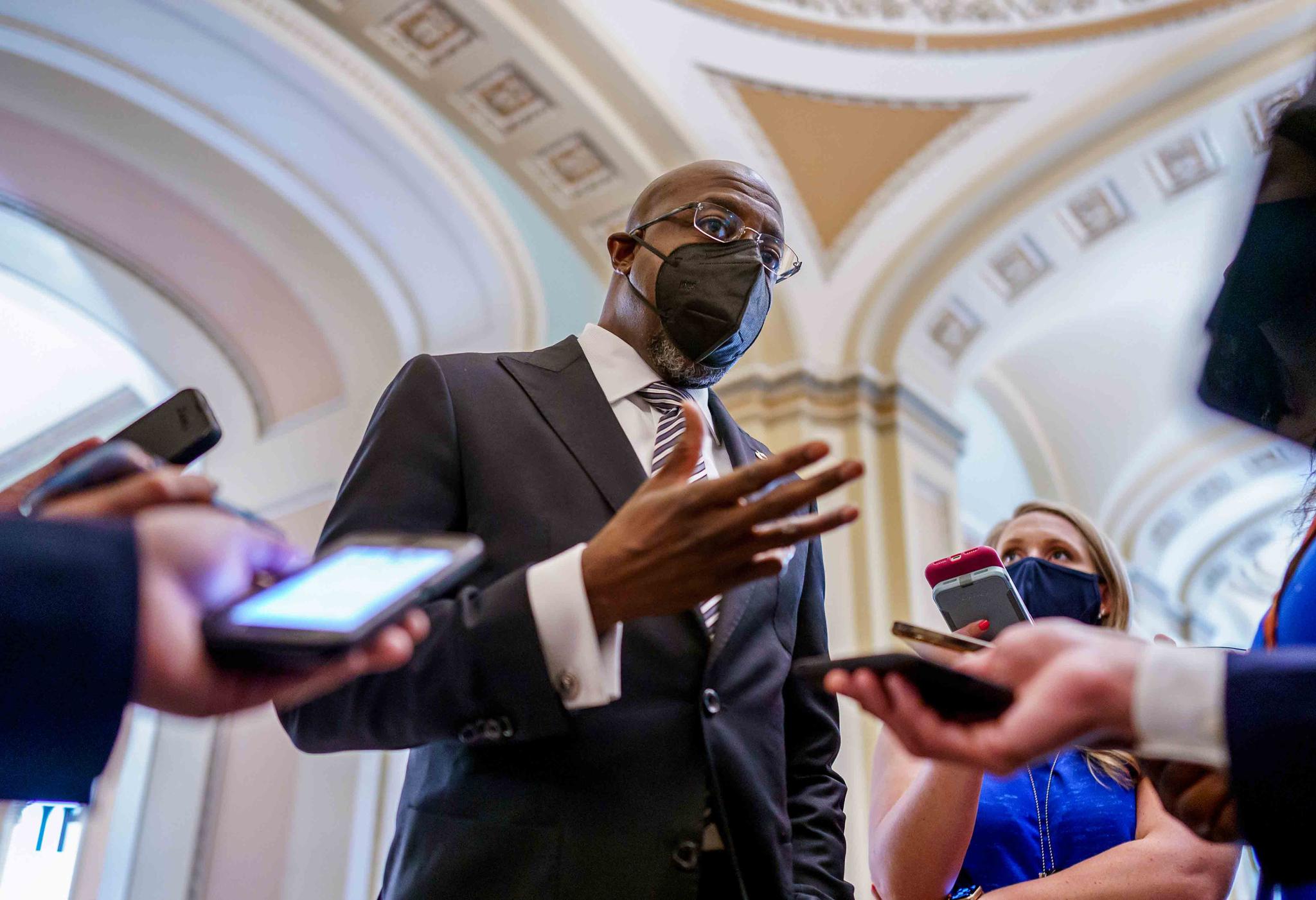 Sen. Raphael Warnock, D-Ga., a key figure on voting rights efforts, speaks to reporters after a huddle with other Democrats as they look to salvage their push to enact voting rights legislation, at the Capitol in Washington, Tuesday, Aug. 10, 2021.