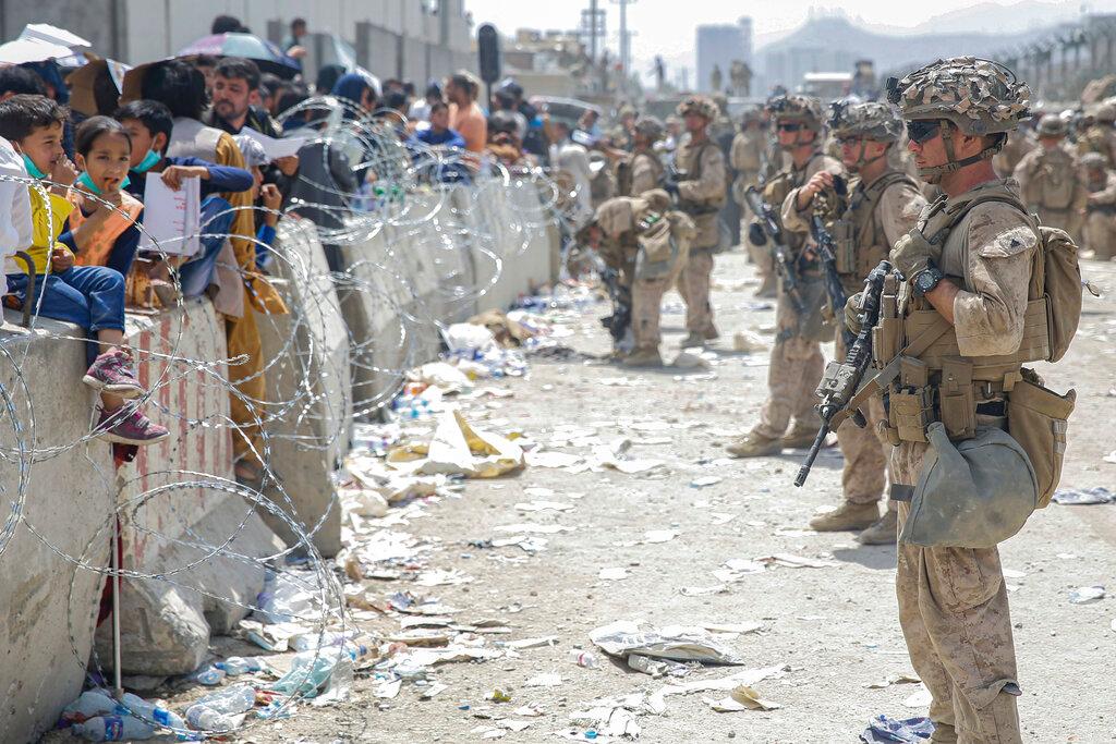 U.S. Marines with Special Purpose Marine Air-Ground Task Force - Crisis Response - Central Command, provide assistance during an evacuation at Hamid Karzai International Airport in Kabul