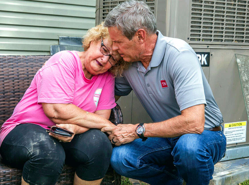 Gov. Bill Lee comforts Shirley Foster, who had just learned a friend of hers died in the flooding