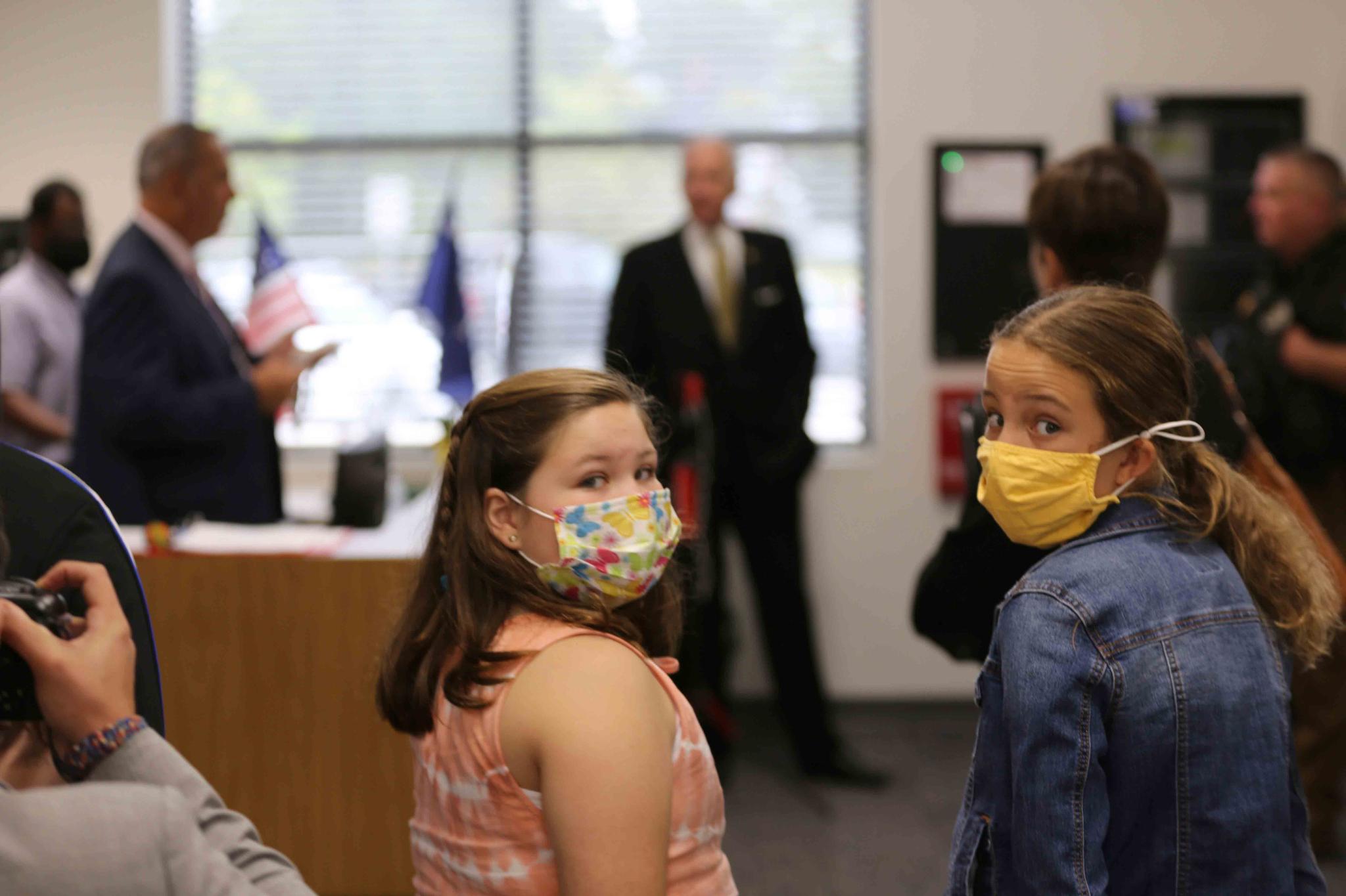 Two Camden Elementary School students in masks listen as South Carolina Gov. Henry McMaster talks about steps the school is taking to fight COVID-19, Wednesday, Sept. 15, 2021, in Camden, S.C.