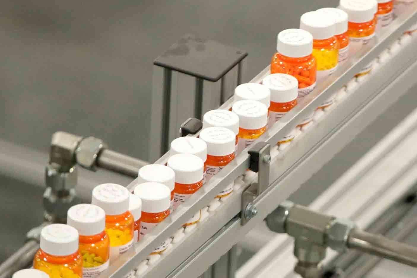 In this July 10, 2018 file photo, bottles of medications ride on a belt at a mail-in pharmacy warehouse in Florence, N.J.