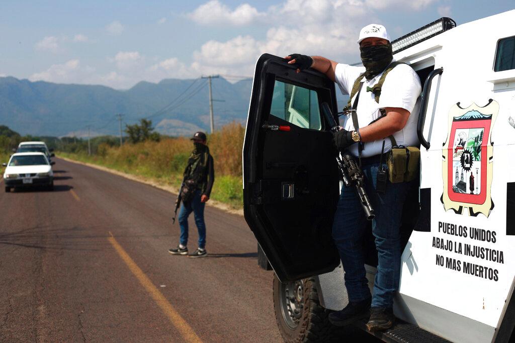 Members of the so-called self-defense group known as United Towns or Pueblos Unidos, gather for a rally in Nuevo Urecho, in the Mexican western state of Michoacan