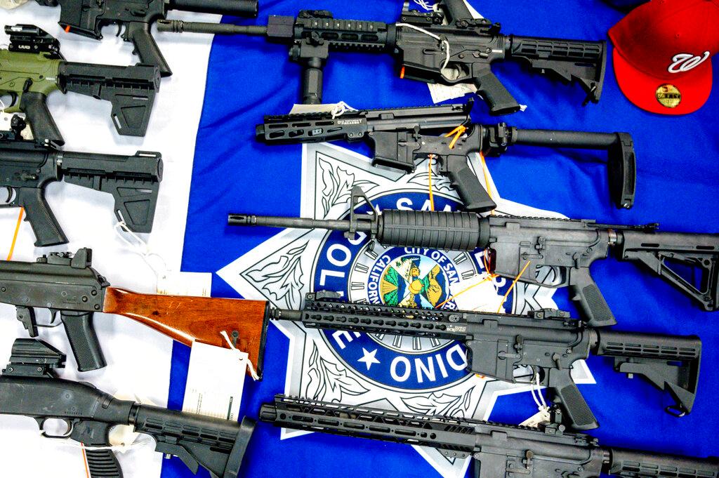 Firearms, seized from a multiagency operation targeting the Westside Verdugo criminal street gang, are displayed during a press conference at the San Bernardino Police Station