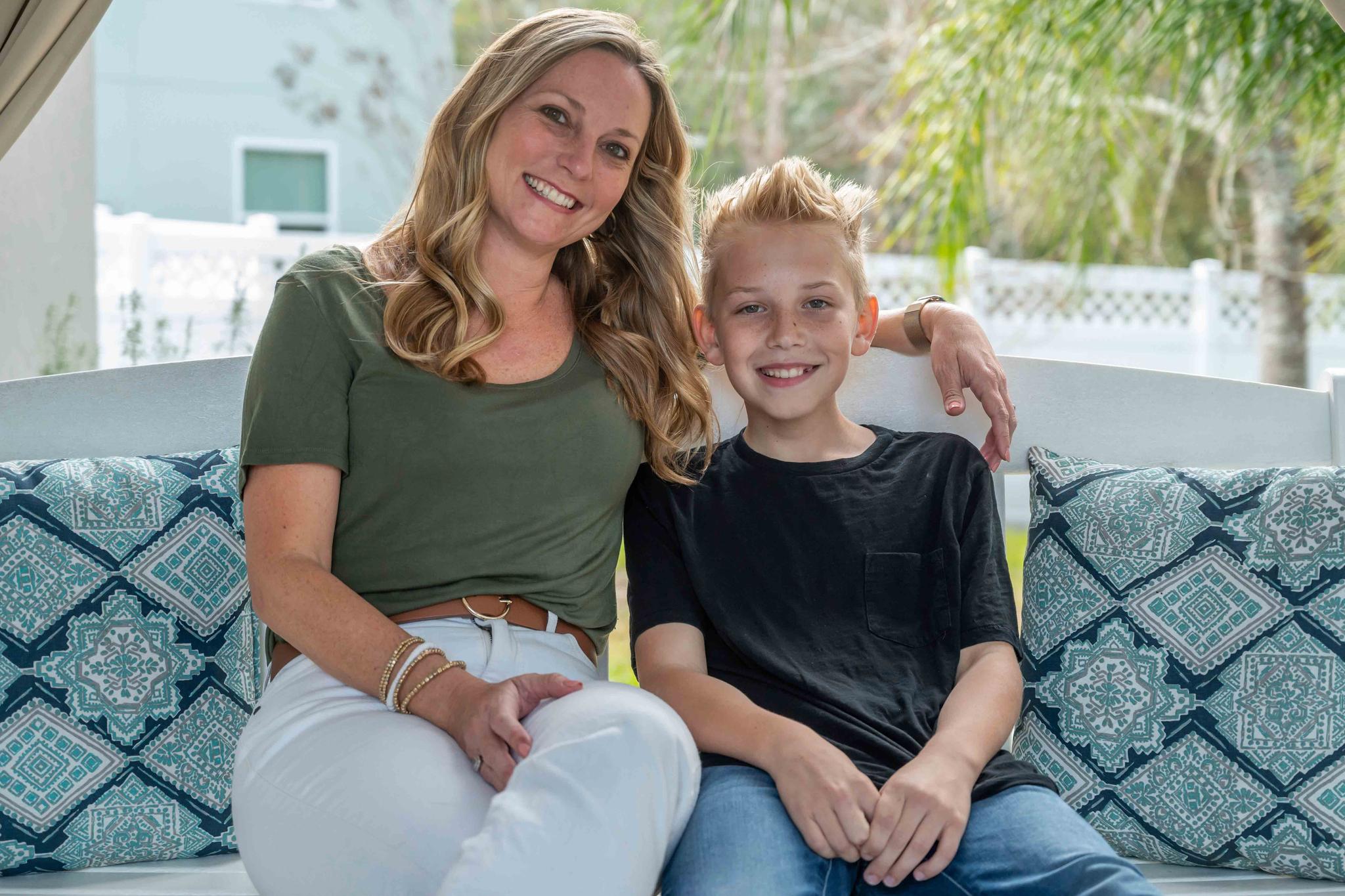 Holly Nover sits with her son, Colton Nover, 10, on a backyard swing at their home Wednesday, Feb. 16, 2022, in St. Johns, Fla.