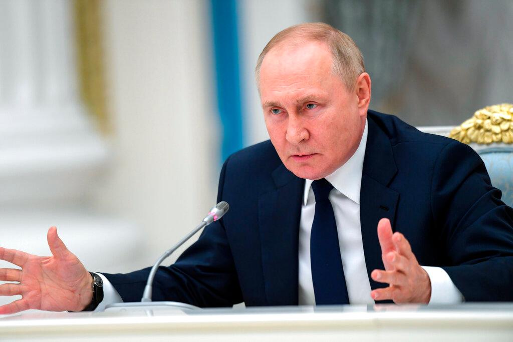 Russian President Vladimir Putin gestures as he speaks to members of the State Duma and the Federal Assembly of The Russian Federation in the Kremlin