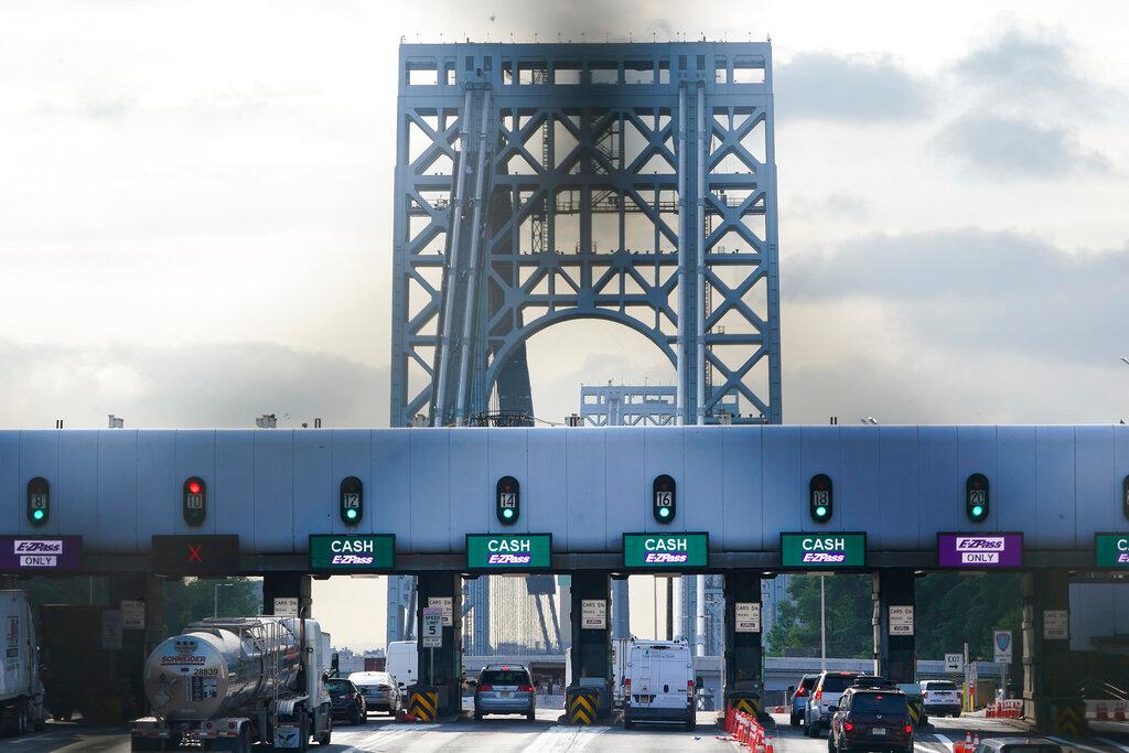 Cars pass through toll booths to use the George Washington Bridge in Fort Lee, N.J., Friday, July 8, 2022. The busy bridge connecting New Jersey and New York City is moving to cashless tolls. Beginning July 10, drivers paying cash tolls will have their license plates scanned and will be billed by mail.