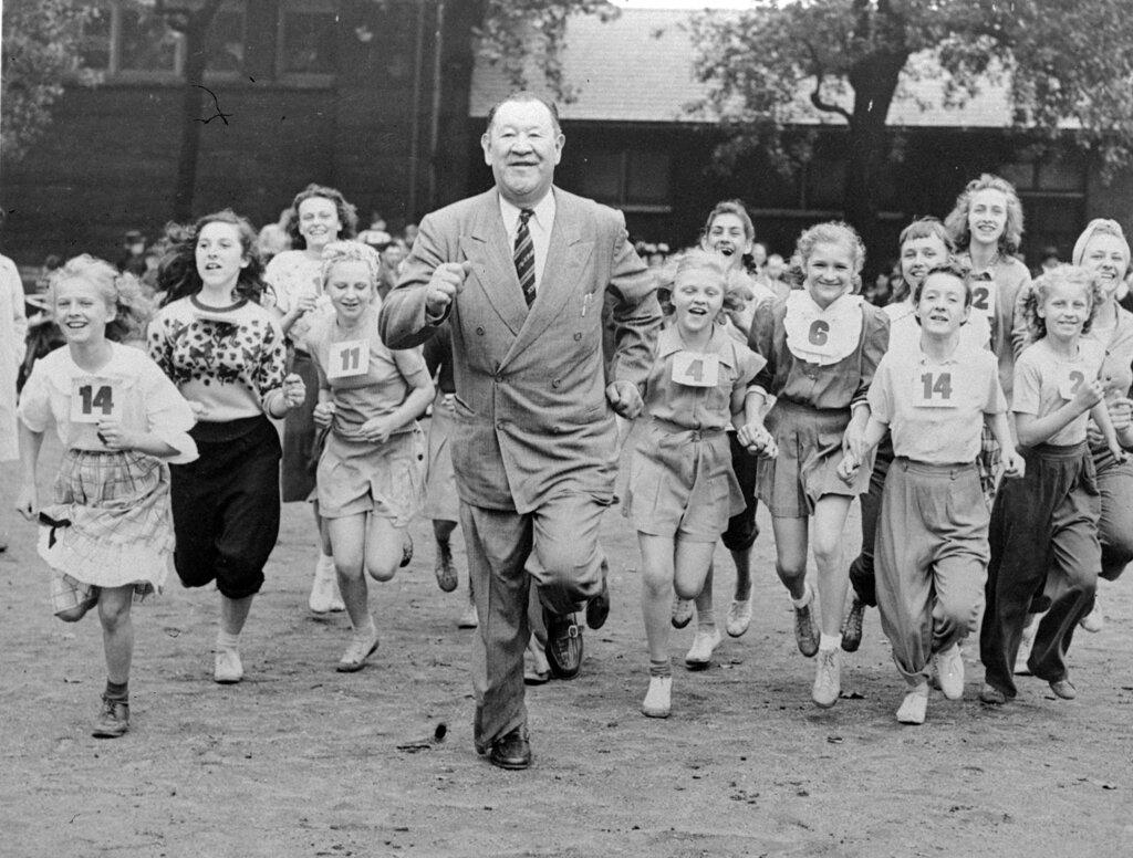 Big Jim Thorpe, famed American athlete and former U.S. Olympic great, center, sets a fast pace for some girls during a "junior olympics" event on Chicago's south side June 6, 1948 