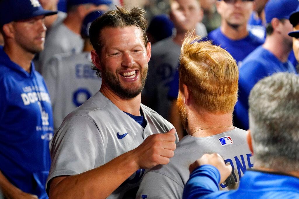 Los Angeles Dodgers starting pitcher Clayton Kershaw, left, hugs Justin Turner after the eighth inning of a baseball game against the Los Angeles Angels 